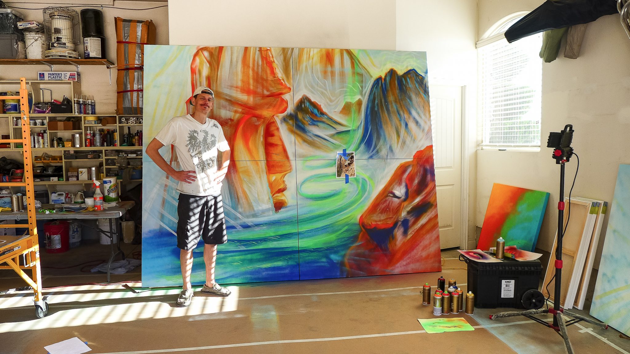 artist mike bowen in front of large painting